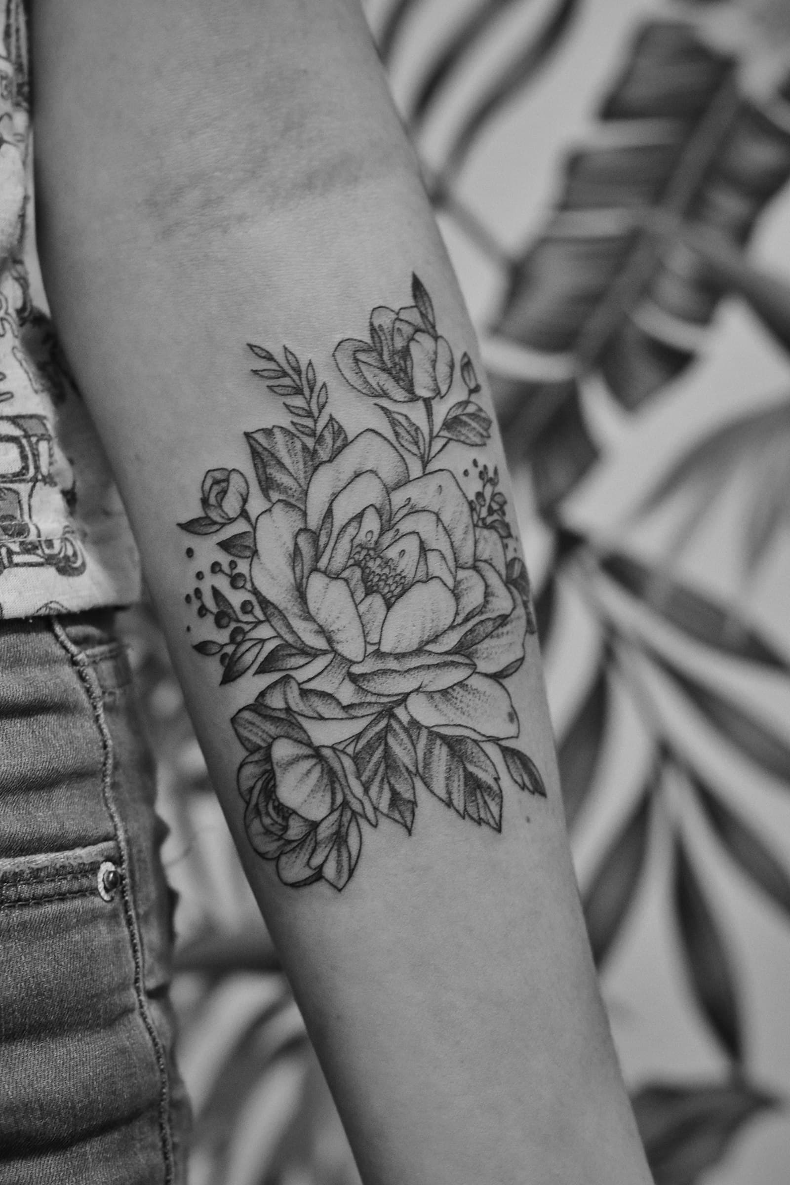 A dotwork peony on a forearm.