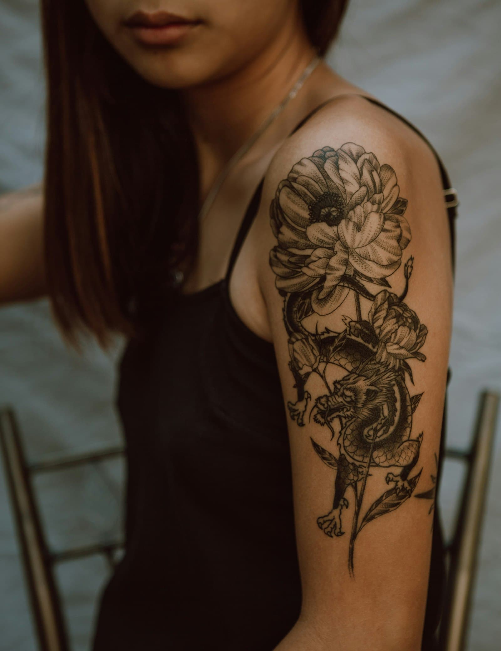 A dragon and peony sleeve on an upper arm.
